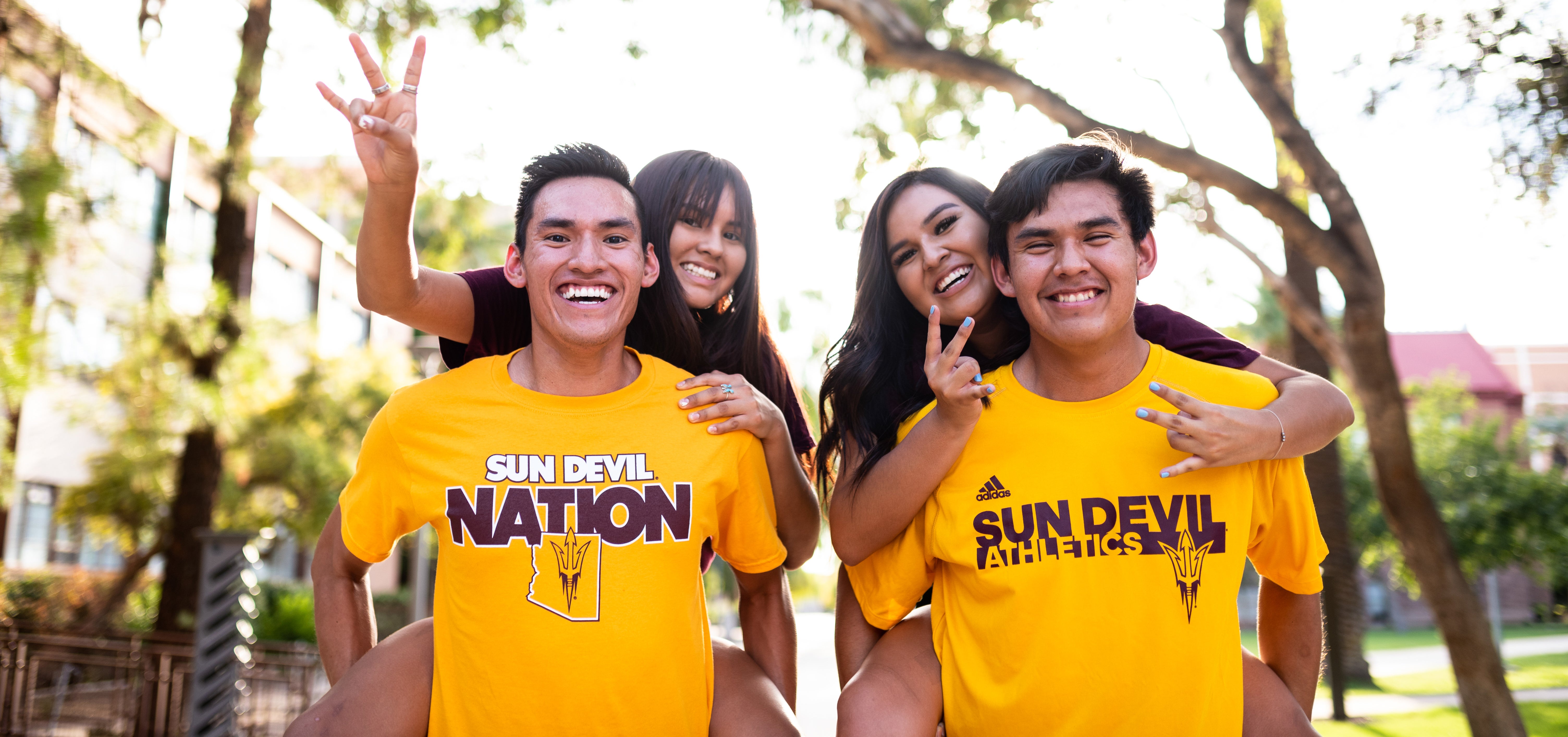 Auto Admit header image - smiling students in sunny outdoors, wearing Sun Devil t-shirts and making pitchfork hand sign