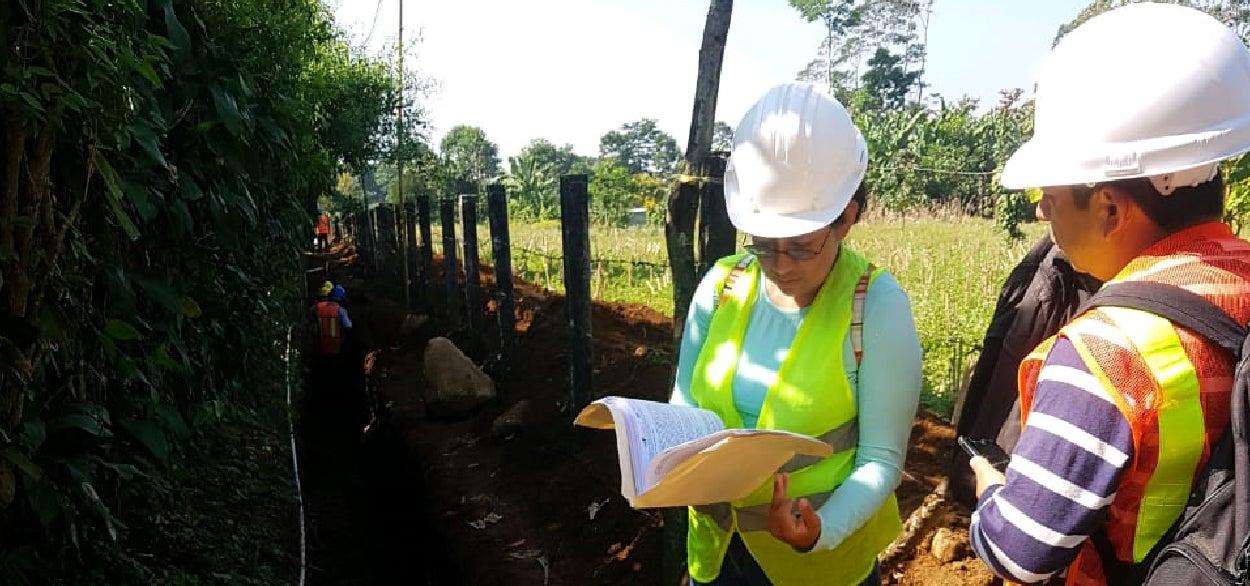 People on-site conversing in hard-hats